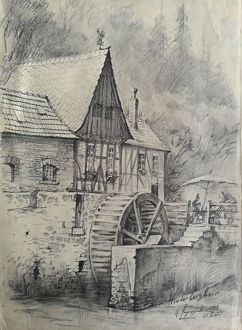 The Mill at Niederbergheim: a half-timbered mill with a pointed tower and a large water wheel, a café umbrella on the terrace